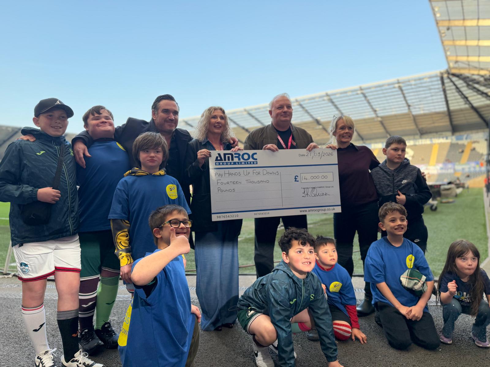 Amroc Heating Raises £14k for Hands Up For Down at Swansea City Match